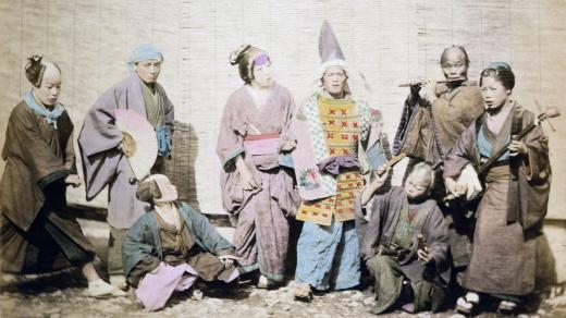 Skupina pouličních muzikantů a herců, Japonsko, 1877. Fotograf: Raimund von Stillfried