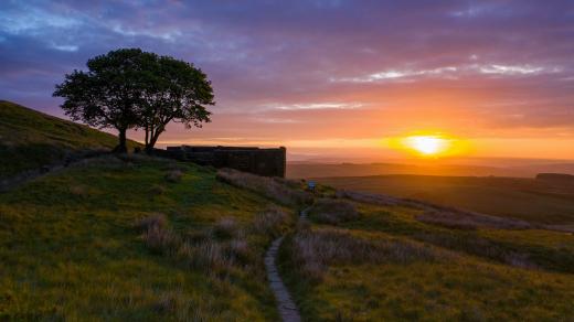 An aerial Sunrise drone shot of Top Withens; Haworth, West Yorkshire, UK