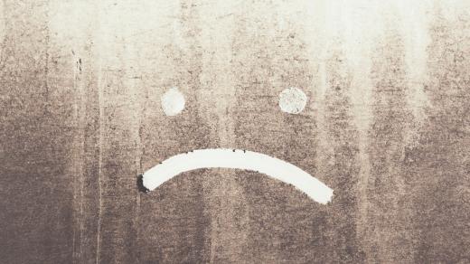 Prach, špína, smutný smajlík, deprese. Ilustrační foto